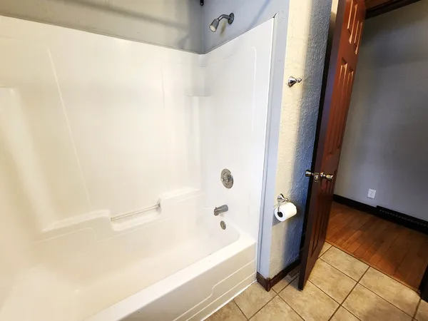 a bathroom with a bathtub and shower