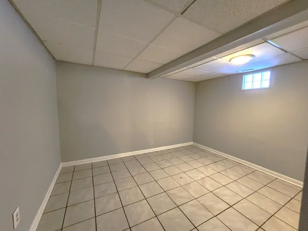 a view of kitchen with windows and refrigerator