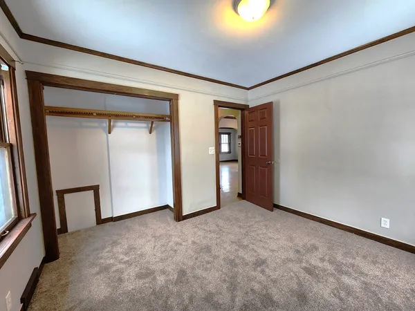 a view of an empty room and a window