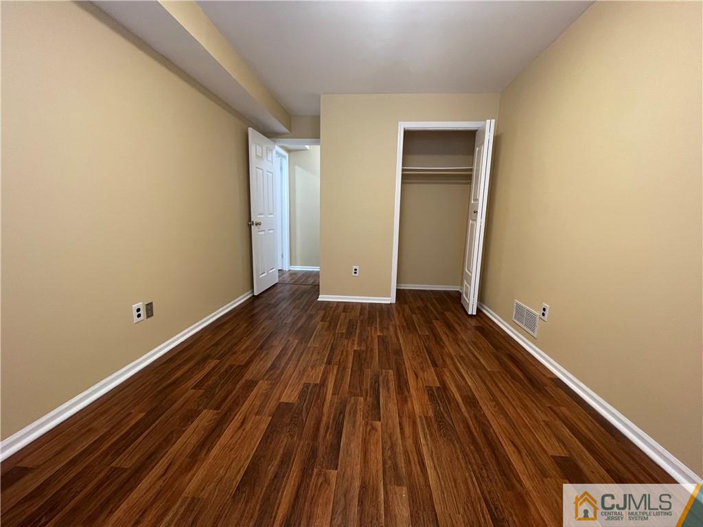 93 C Woodbridge Terrace, Unit 9303 Woodbridge, NJ 07095 - Photo 11 of 14 a view of wooden floor in a room