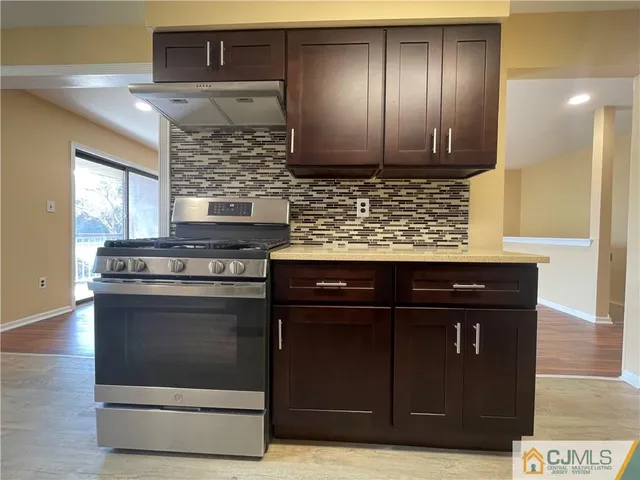 a kitchen with stainless steel appliances wooden cabinets and stove