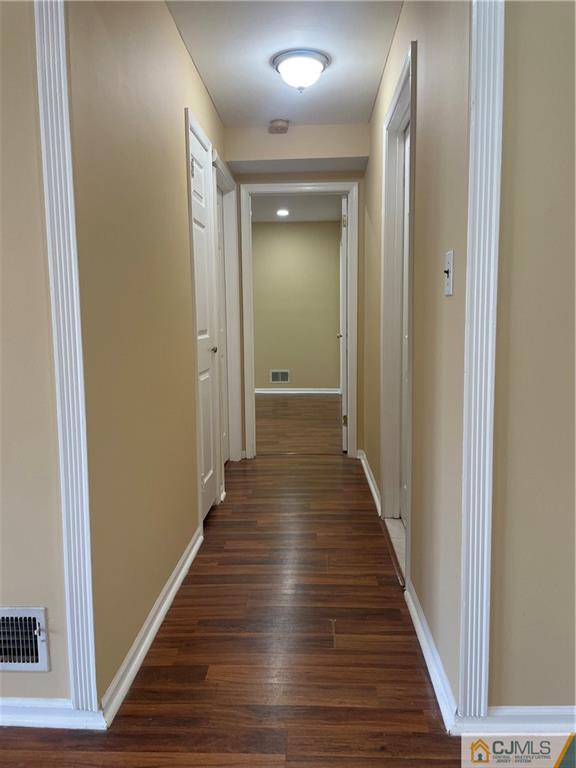 93 C Woodbridge Terrace, Unit 9303 Woodbridge, NJ 07095 - Photo 6 of 14 a view of a hallway with wooden floor
