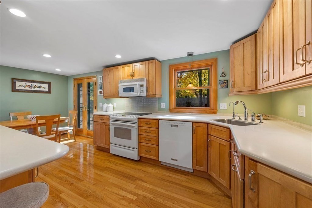 7 Irving Road Natick, MA 01760 - Photo 12 of 39 a kitchen with stainless steel appliances granite countertop a sink a stove and a wooden floors