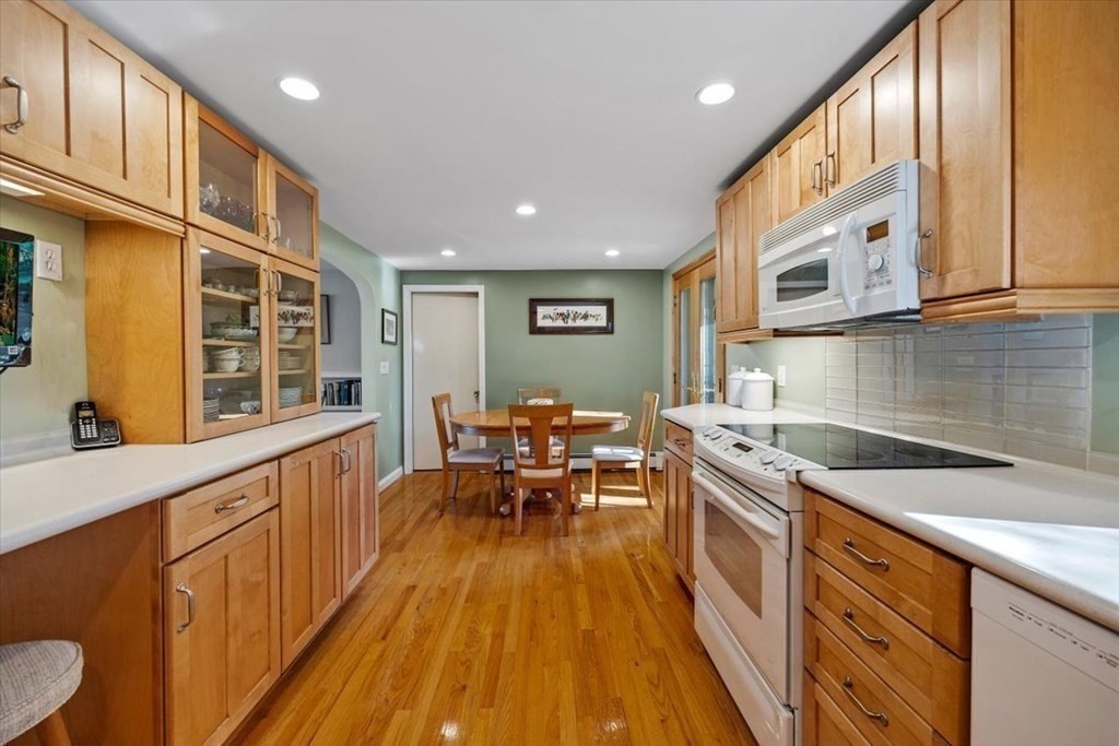 7 Irving Road Natick, MA 01760 - Photo 13 of 39 a large kitchen with stainless steel appliances granite countertop a lot of cabinets counter space a sink and a window