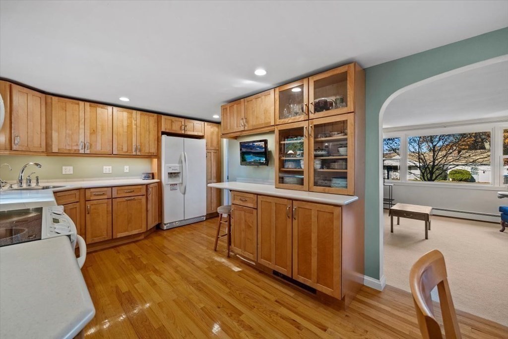 7 Irving Road Natick, MA 01760 - Photo 14 of 39 a kitchen with stainless steel appliances granite countertop a stove a sink dishwasher and a refrigerator with wooden cabinets