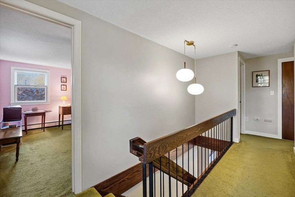 7 Irving Road Natick, MA 01760 - Photo 23 of 39 a view of a hallway with couches and dining room view