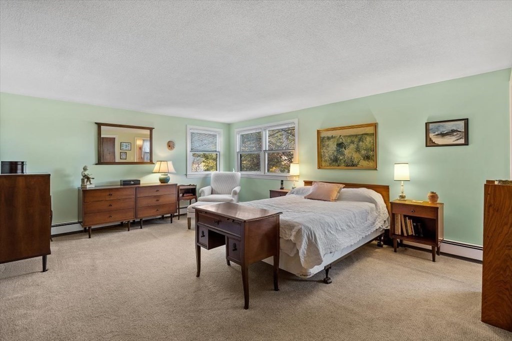 7 Irving Road Natick, MA 01760 - Photo 25 of 39 a spacious bedroom with a bed a table and chair