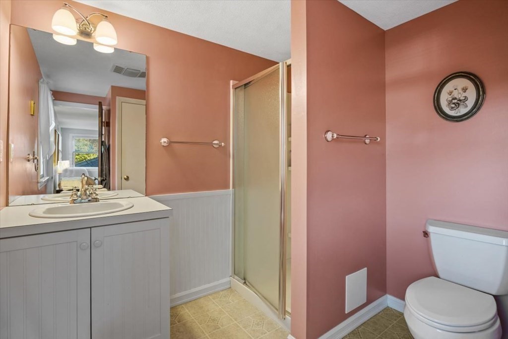 7 Irving Road Natick, MA 01760 - Photo 28 of 39 a bathroom with a sink a toilet and a mirror