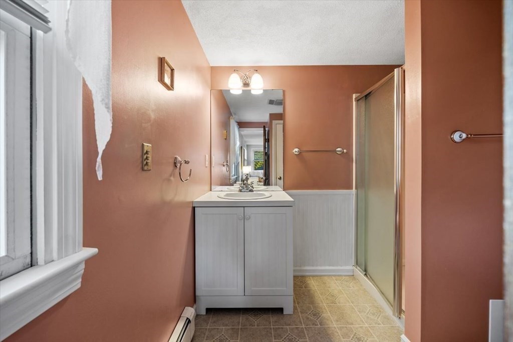 7 Irving Road Natick, MA 01760 - Photo 29 of 39 a bathroom with a sink and a mirror