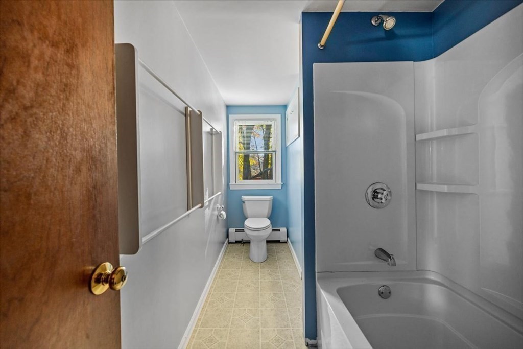 7 Irving Road Natick, MA 01760 - Photo 31 of 39 a bathroom with a tub shower and toilet