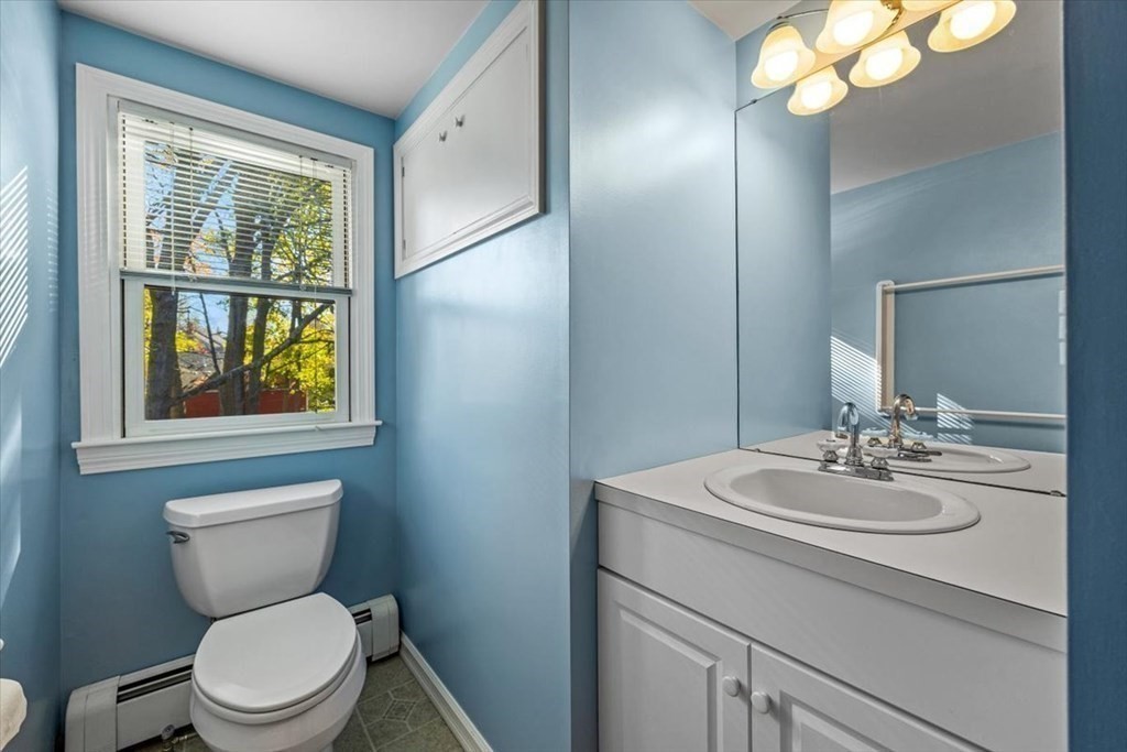 7 Irving Road Natick, MA 01760 - Photo 32 of 39 a bathroom with a toilet a sink and a mirror