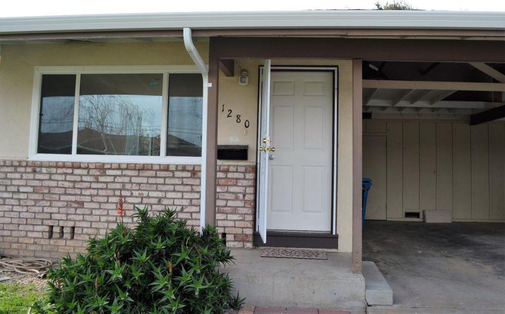 1280 White Drive Santa Clara, CA 95051 - Photo 2 of 10 a front view of a house with a garage