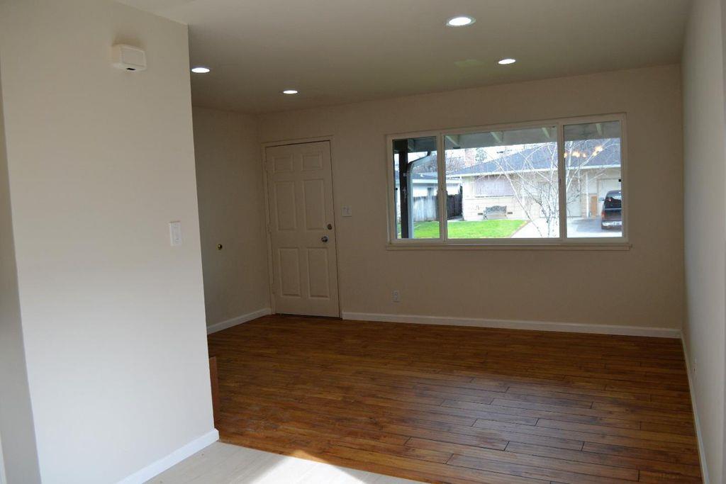 1280 White Drive Santa Clara, CA 95051 - Photo 9 of 10 an empty room with wooden floor and windows