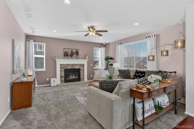 a living room with furniture and a fireplace