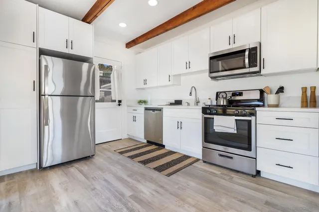 a bedroom with a bed and a painting on the wall