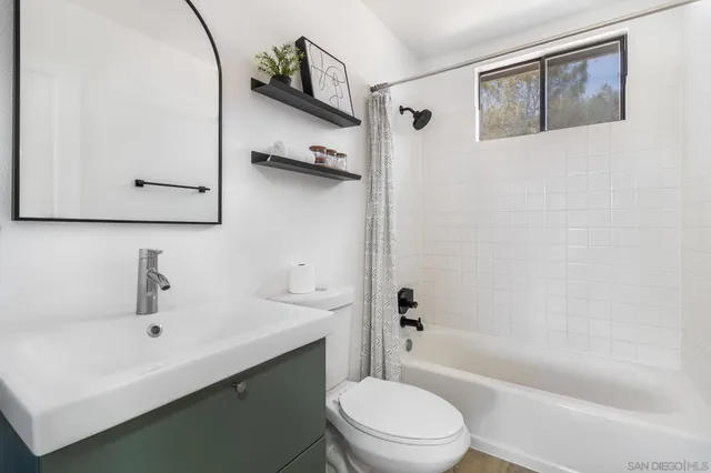 a view of sitting area with furniture and wooden floor