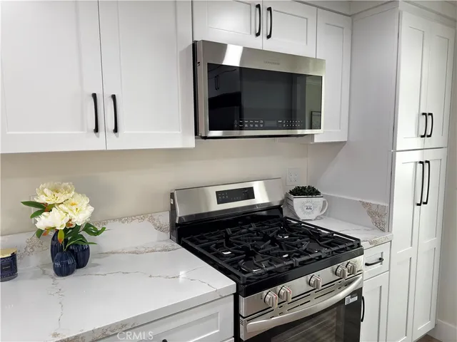 a kitchen with a stove and a microwave