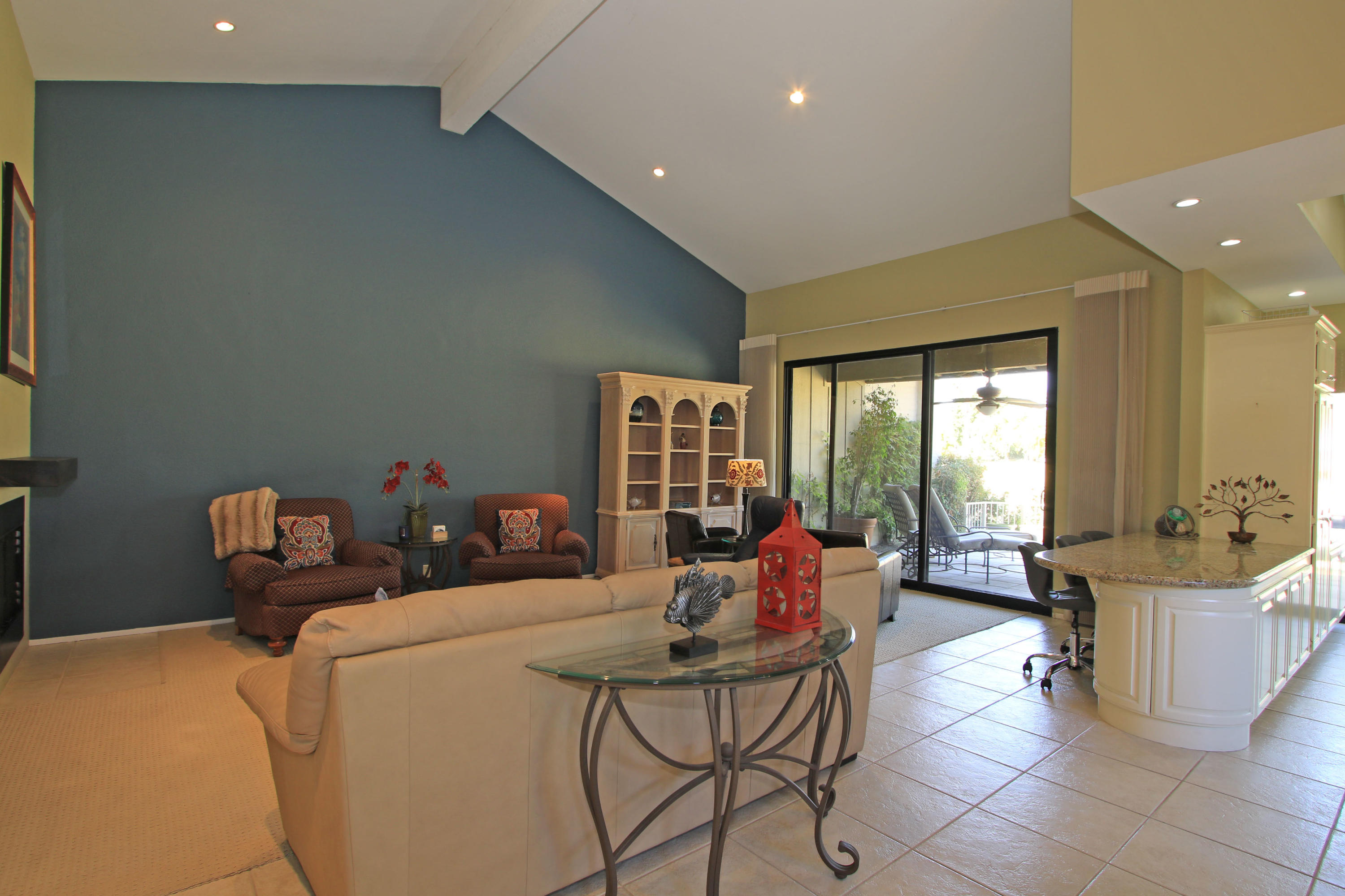 368 Red River Road Palm Desert, CA 92211 - Photo 7 of 36 a living room with fireplace furniture and a large window