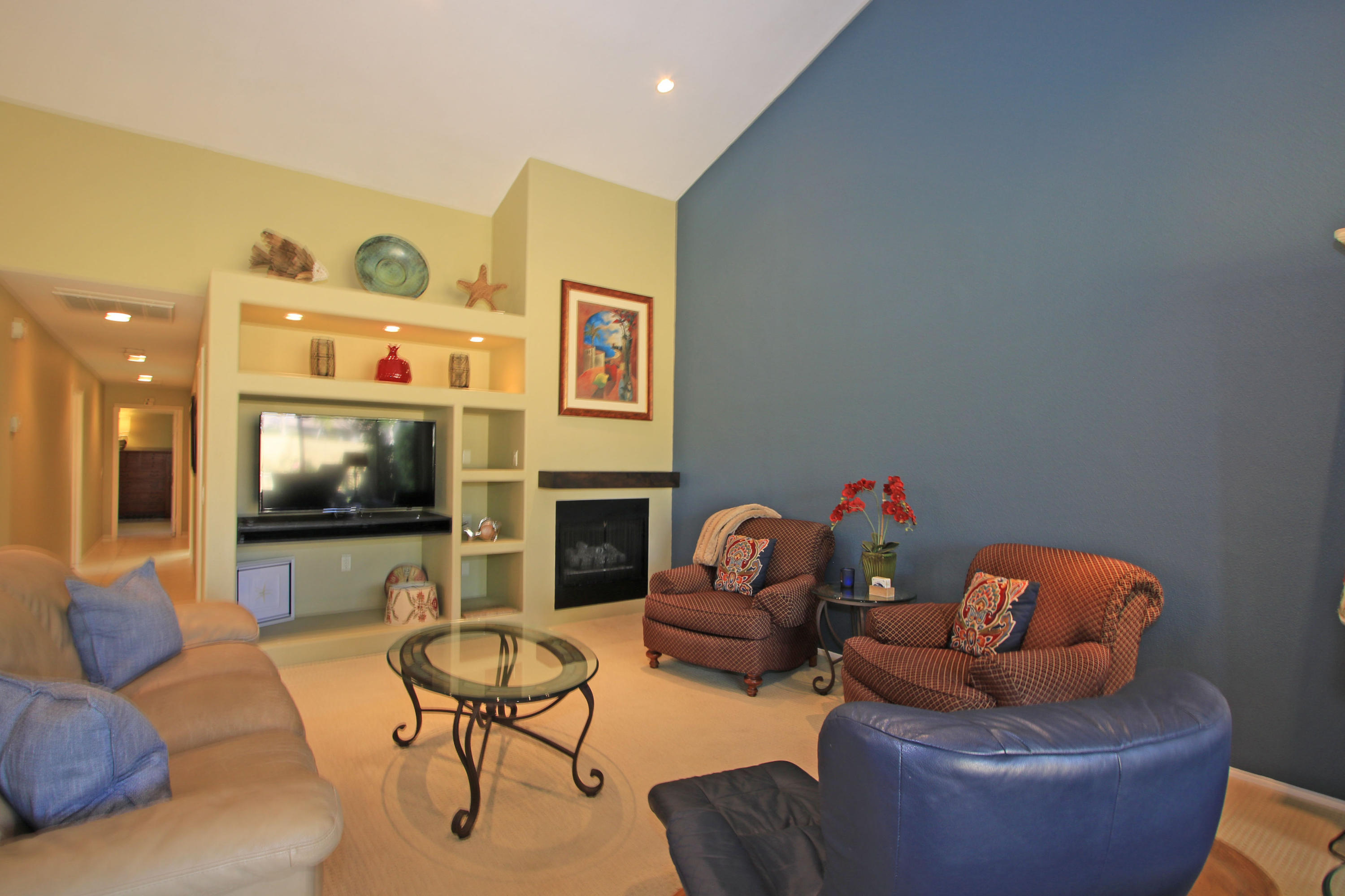 368 Red River Road Palm Desert, CA 92211 - Photo 10 of 36 a living room with furniture a flat screen tv and a fireplace