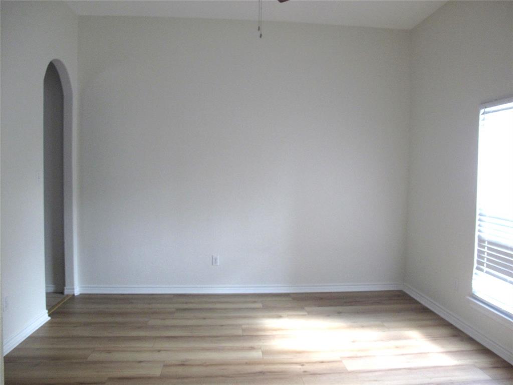 303 Quail Run Road Red Oak, TX 75154 - Photo 12 of 19 a view of a room with wooden floor and a window