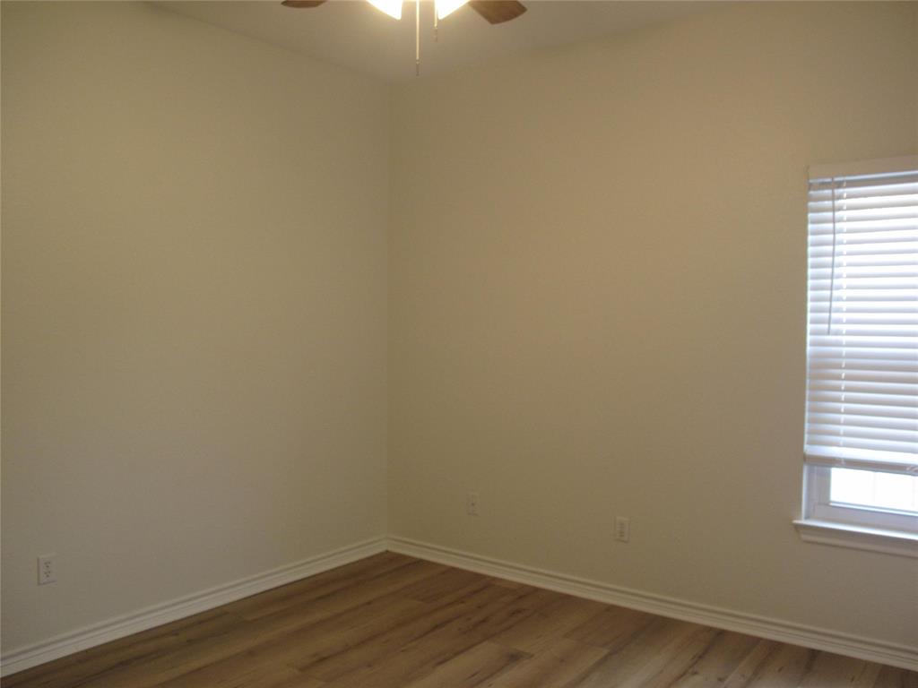 303 Quail Run Road Red Oak, TX 75154 - Photo 16 of 19 a view of a small space with wooden floor and a window