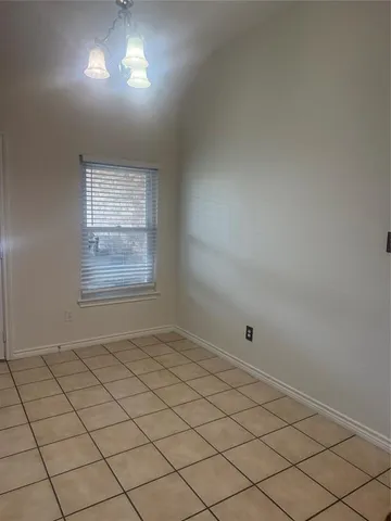 a view of an empty room and a window