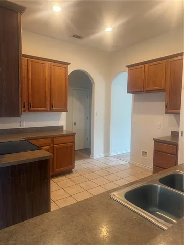 a kitchen with stainless steel appliances a sink a stove and a refrigerator