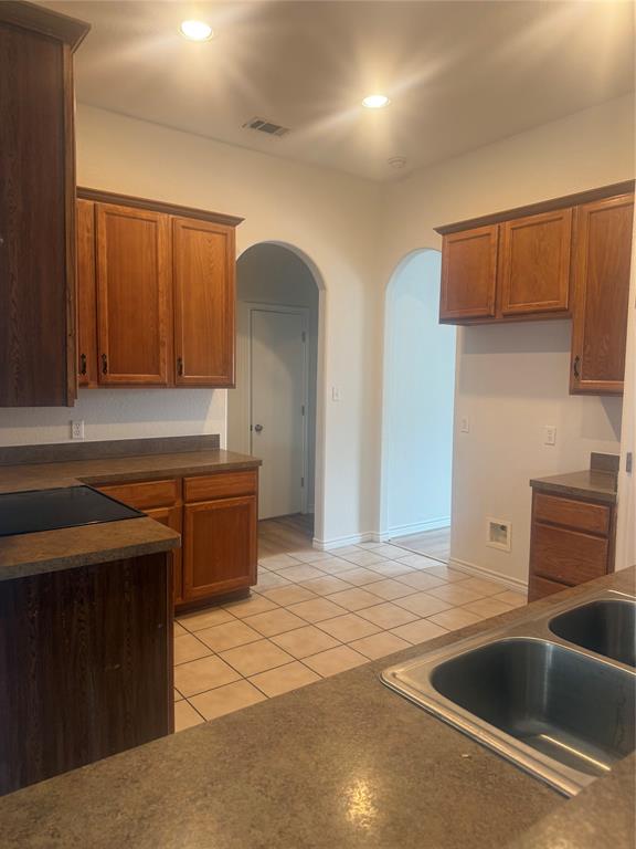 303 Quail Run Road Red Oak, TX 75154 - Photo 5 of 19 a kitchen with stainless steel appliances a sink a stove and a refrigerator