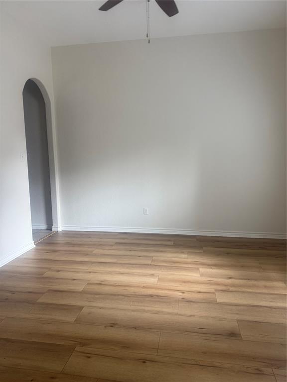 303 Quail Run Road Red Oak, TX 75154 - Photo 9 of 19 a view of a room with wooden floor and fan