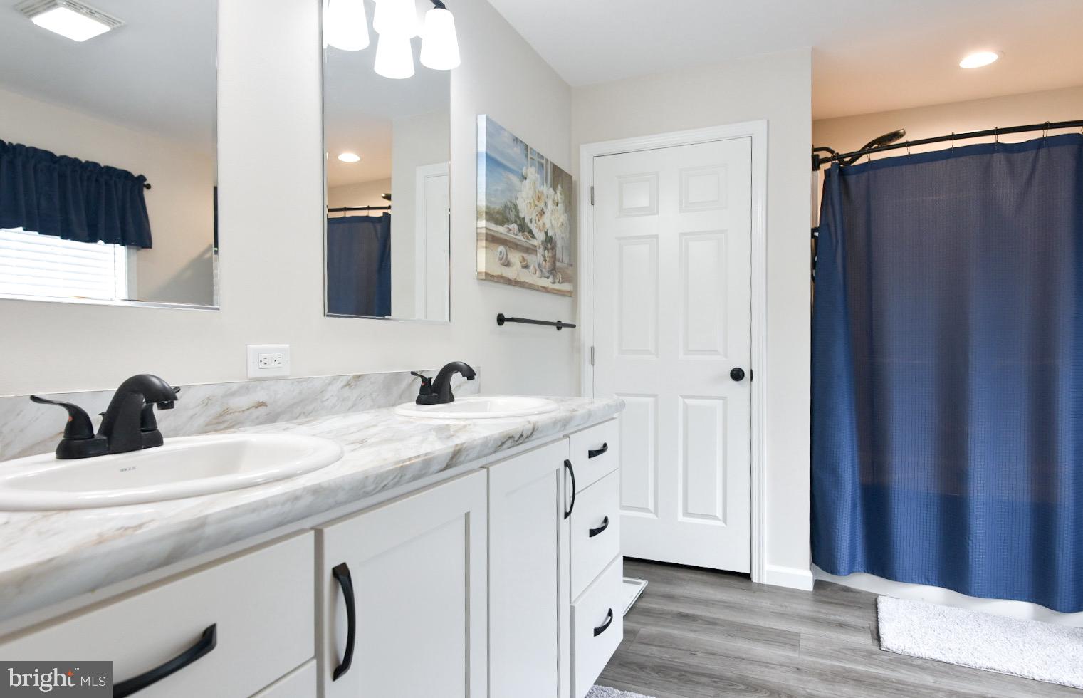 33510 Deer Run Road Frankford, DE 19945 - Photo 14 of 53 a bathroom with a double vanity sink and a mirror