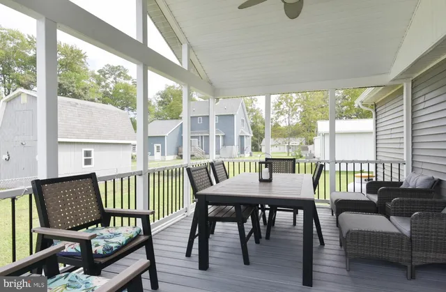 a front view of house with yard barbeque and outdoor seating