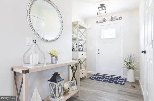 a kitchen with stainless steel appliances a stove a sink and white cabinets