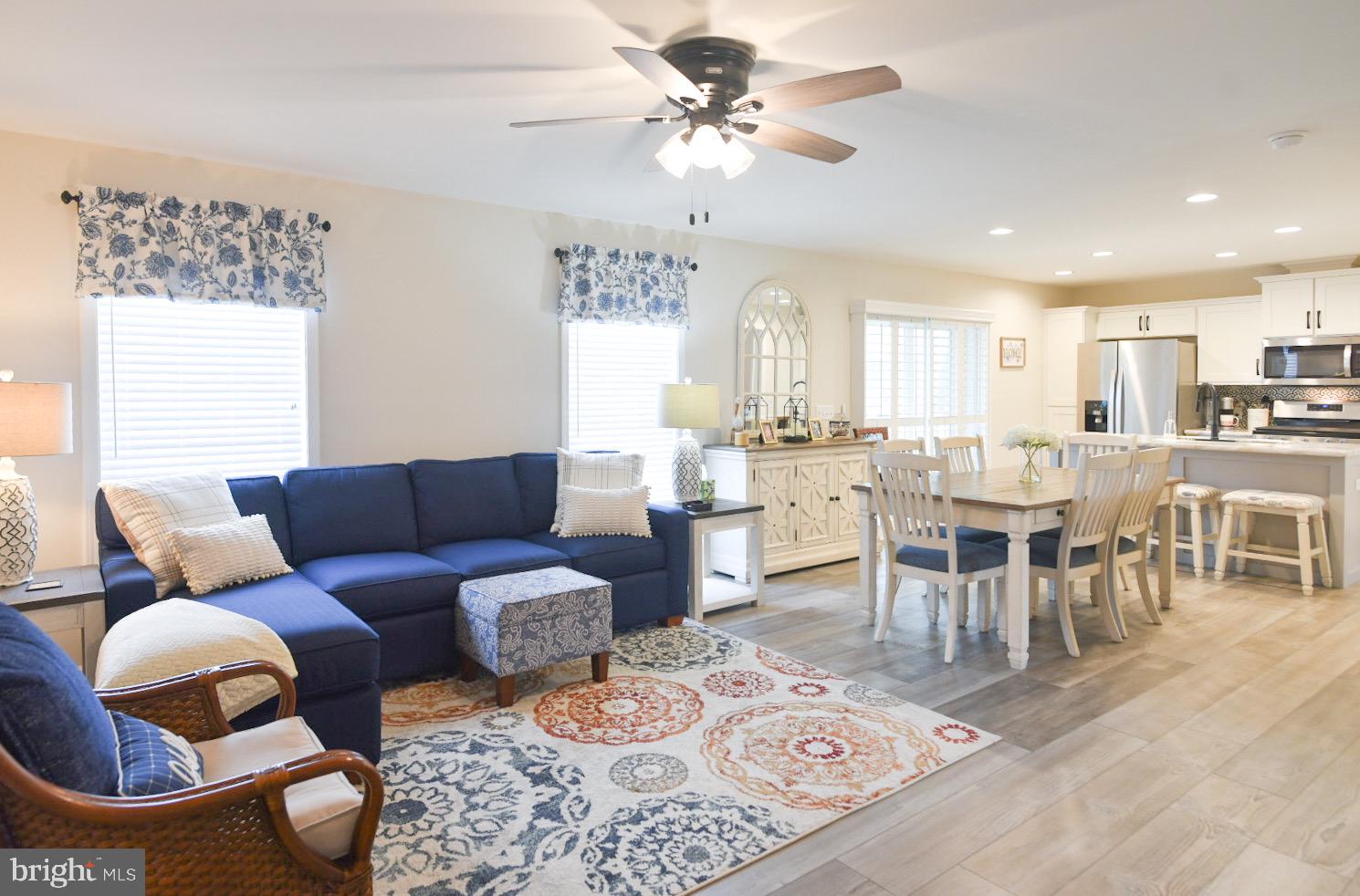 33510 Deer Run Road Frankford, DE 19945 - Photo 24 of 53 a living room with lots of furniture and a chandelier