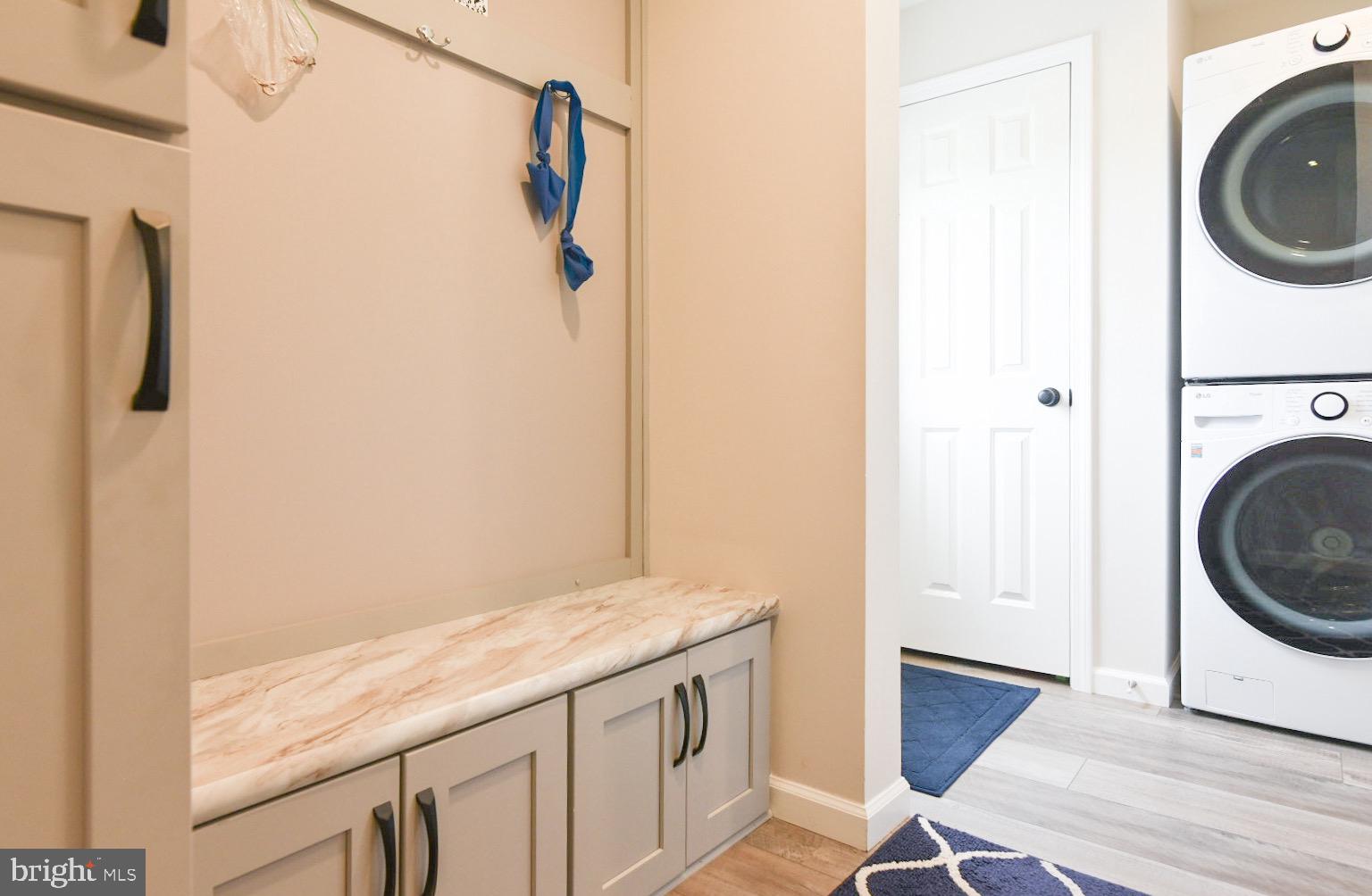 33510 Deer Run Road Frankford, DE 19945 - Photo 34 of 53 a bathroom with a granite countertop shower a washer and dryer