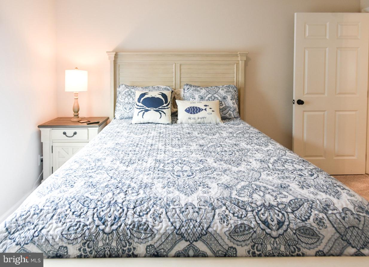 33510 Deer Run Road Frankford, DE 19945 - Photo 42 of 53 a bed sitting in a bedroom next to a window and a chair