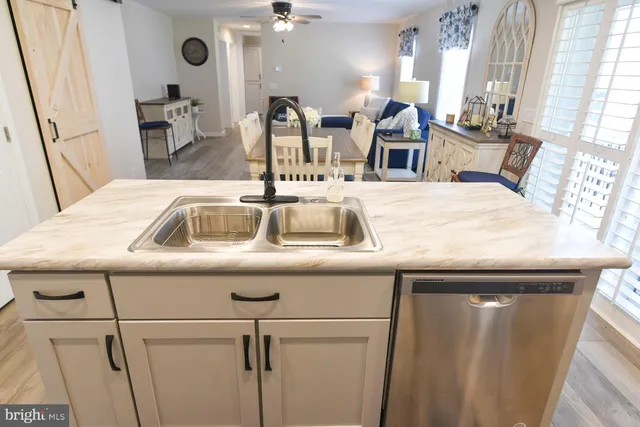 a kitchen with stainless steel appliances granite countertop a sink a stove a microwave and cabinets