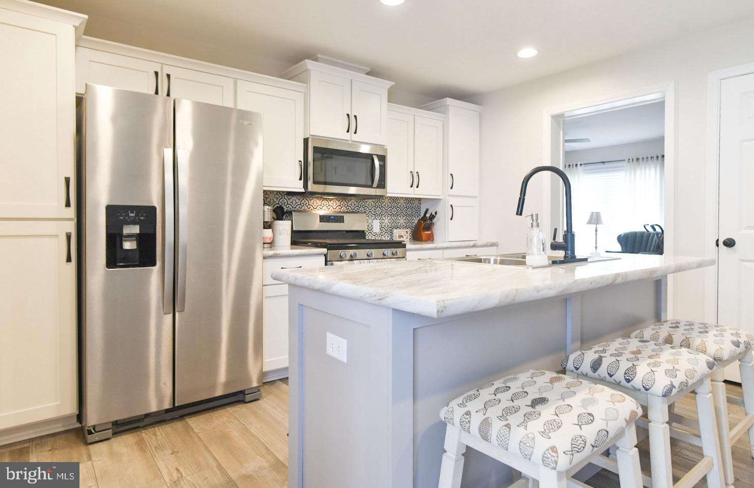 33510 Deer Run Road Frankford, DE 19945 - Photo 10 of 53 a kitchen with stainless steel appliances granite countertop a refrigerator sink and stove
