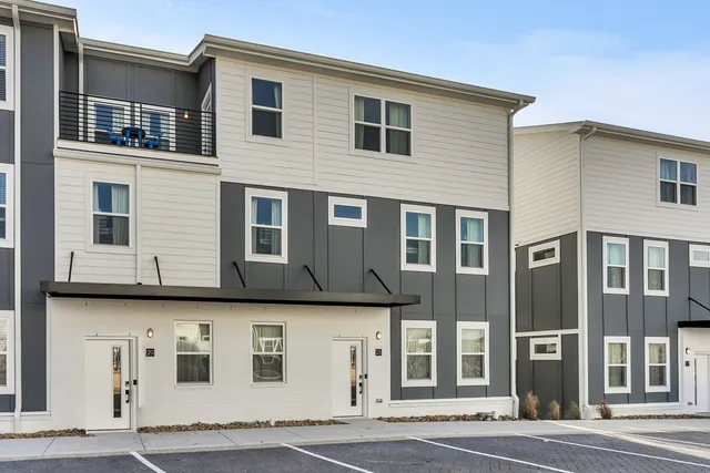 a view of a building with a parking area