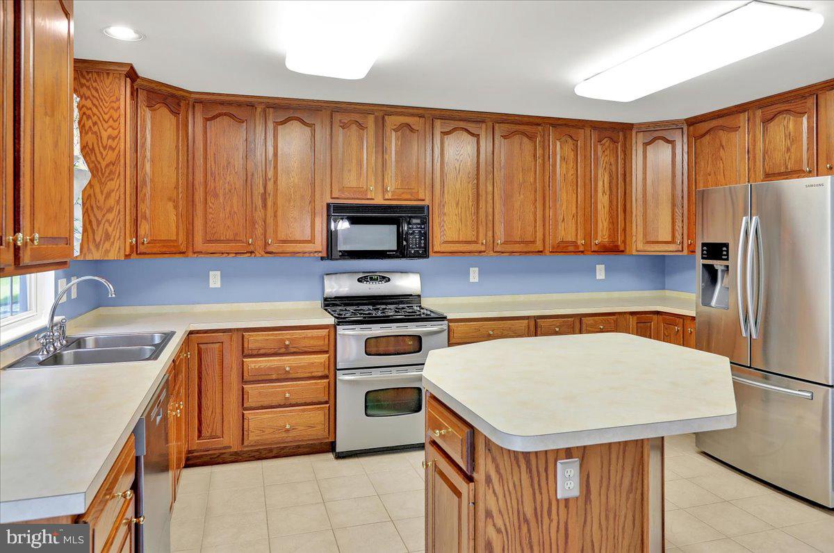 203 Barrington Drive Reading, PA 19607 - Photo 11 of 44 a kitchen with a stove a sink and a refrigerator