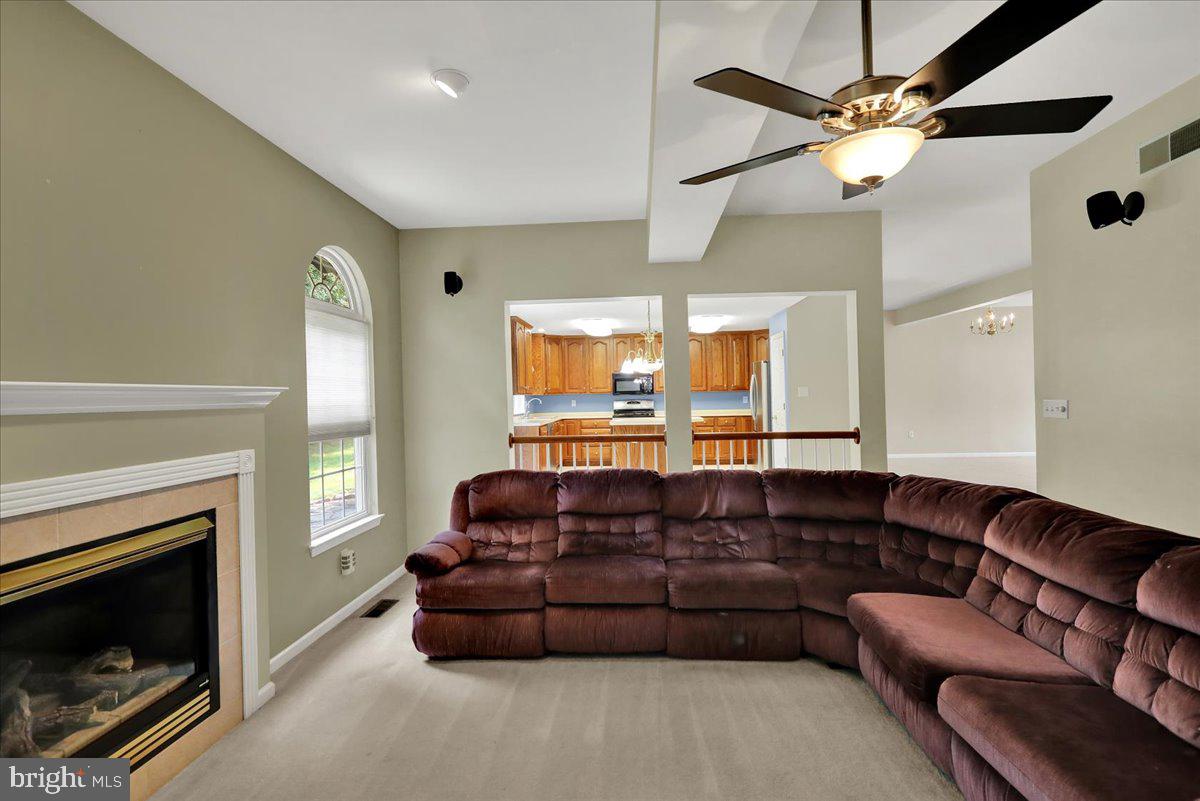 203 Barrington Drive Reading, PA 19607 - Photo 15 of 44 a living room with furniture a fireplace and a large window