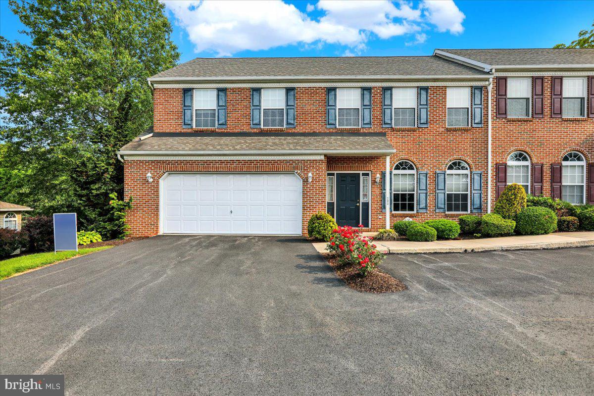 203 Barrington Drive Reading, PA 19607 - Photo 3 of 44 a front view of a house with a garden and porch