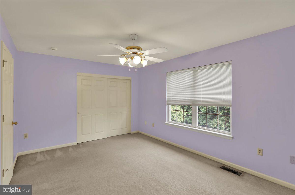 203 Barrington Drive Reading, PA 19607 - Photo 31 of 44 an empty room with windows and chandelier fan