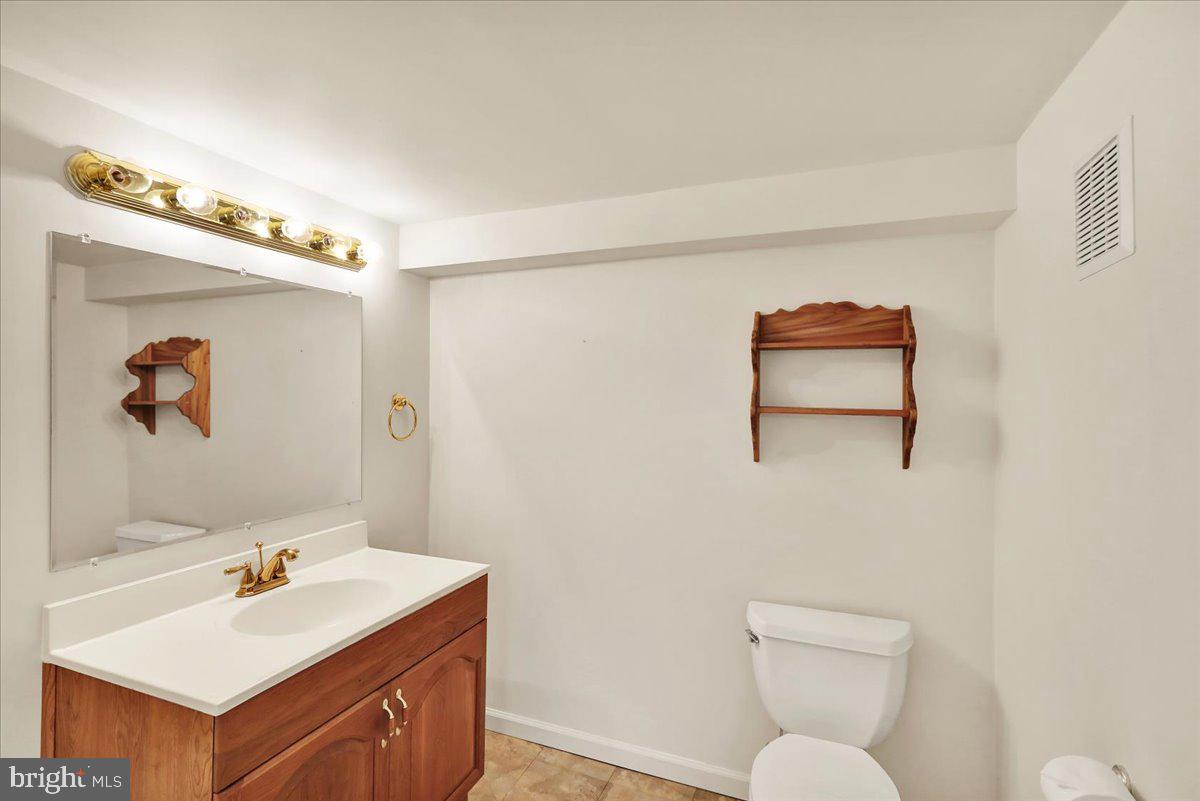 203 Barrington Drive Reading, PA 19607 - Photo 40 of 44 a bathroom with a sink mirror vanity and toilet