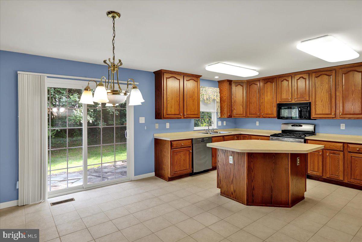 203 Barrington Drive Reading, PA 19607 - Photo 9 of 44 a kitchen with stainless steel appliances granite countertop a stove a sink dishwasher a refrigerator and a wooden cabinets