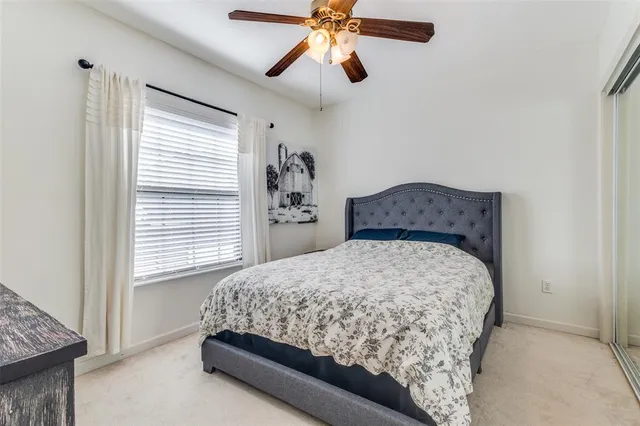 a bathroom with a granite countertop toilet sink and mirror