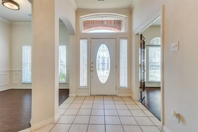 a view of an entryway with wooden floor and door