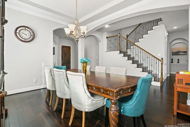 a view of a dining room with furniture and a chandelier