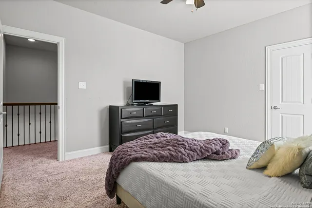 a bedroom with a bed and a television