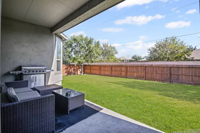 a view of backyard with outdoor seating
