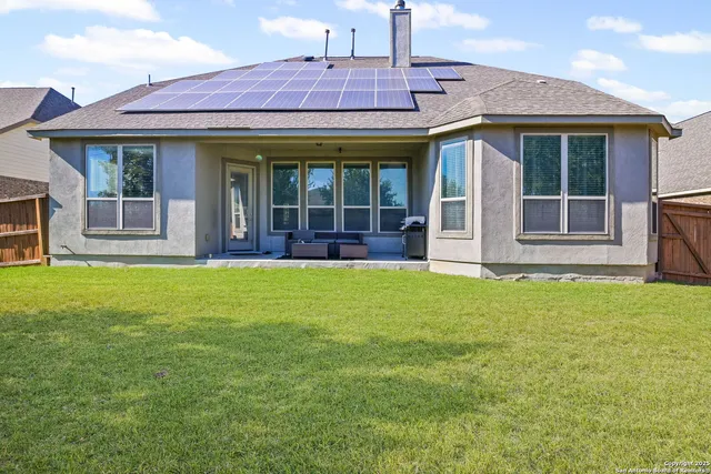 a view of a house with a backyard